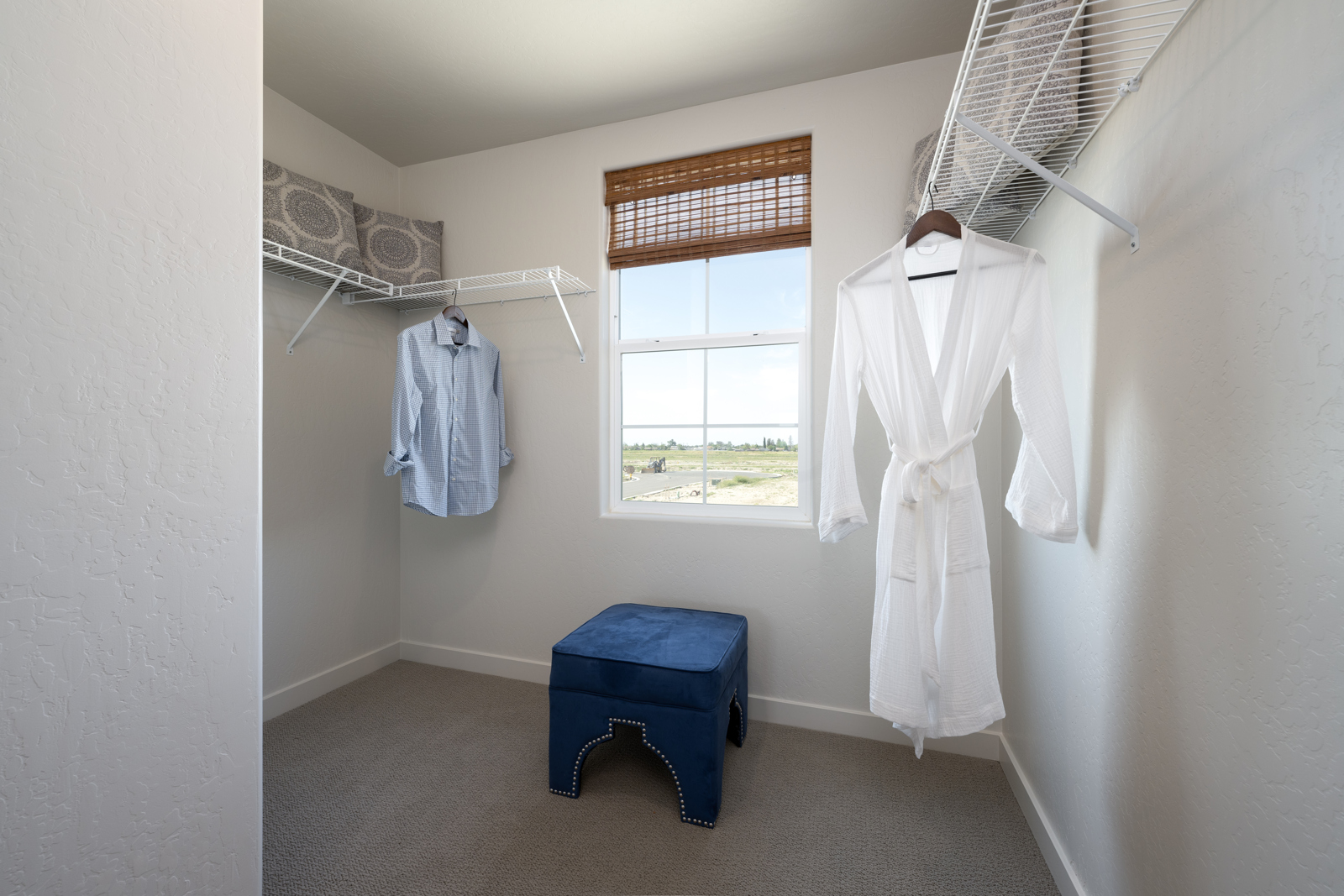 A room with clothes on the wall.