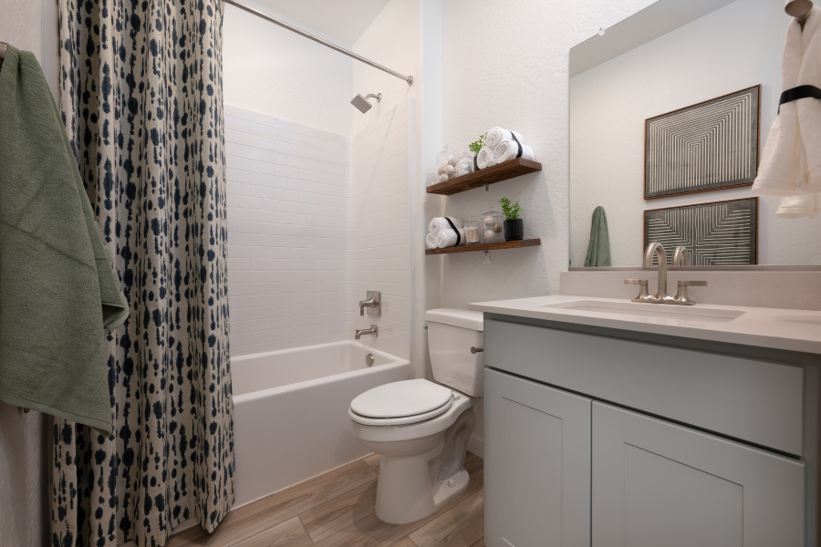 A bathroom with a tub sink and toilet.