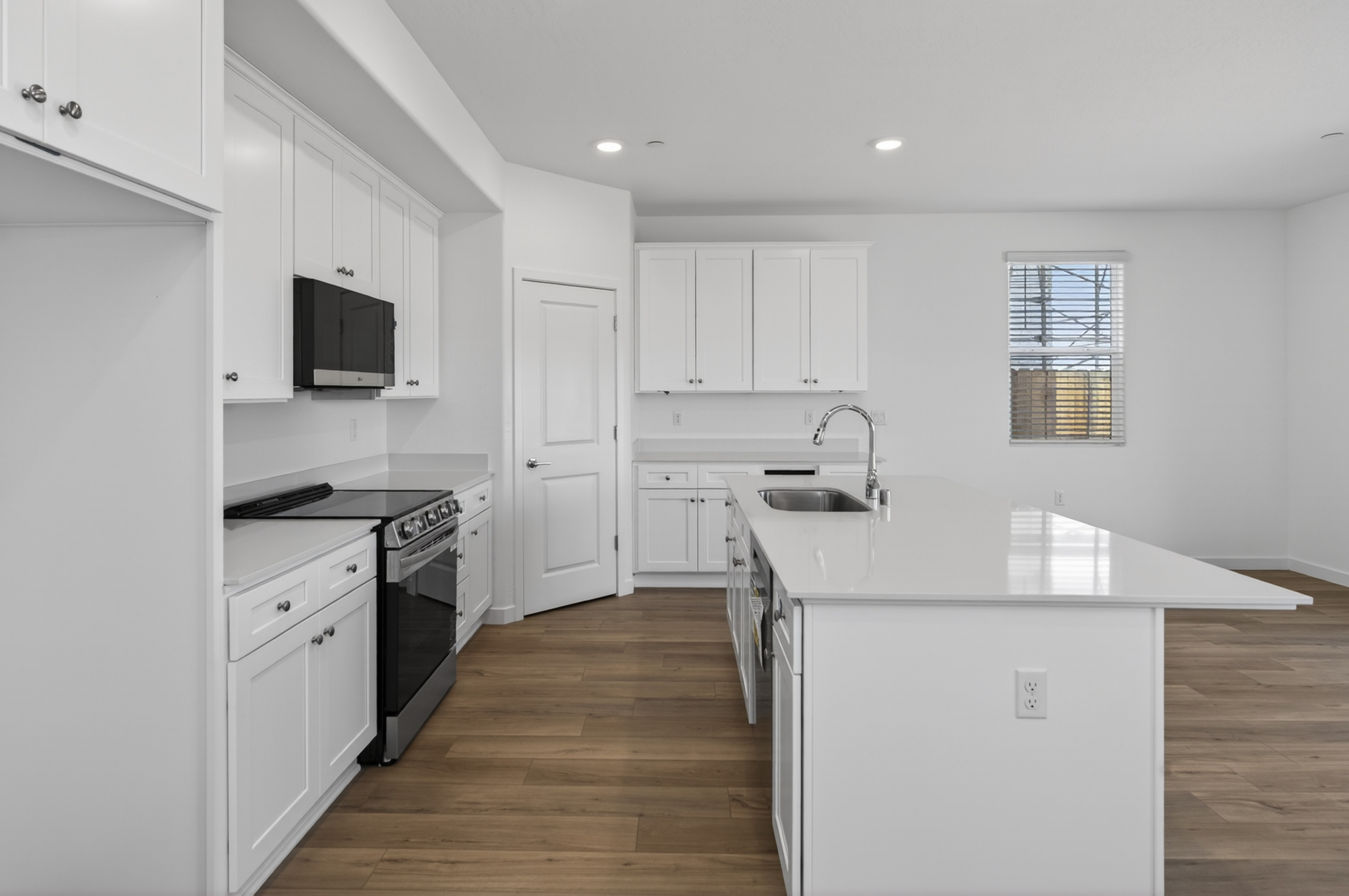 A kitchen with white cabinets.
