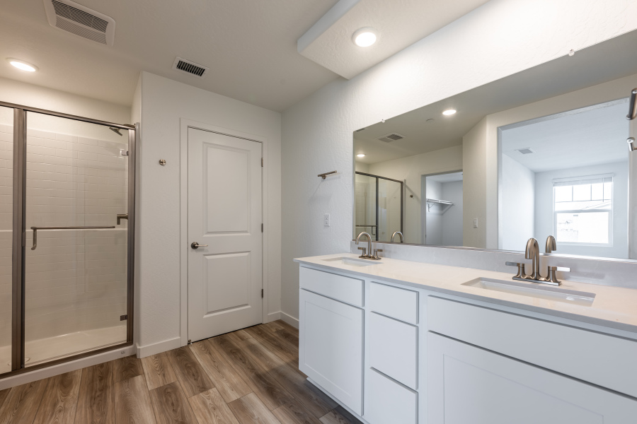 A bathroom with white cabinets.