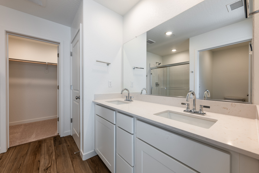 A bathroom with a large mirror.