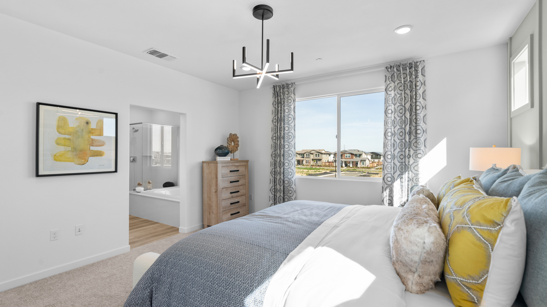 A bedroom with a large window.