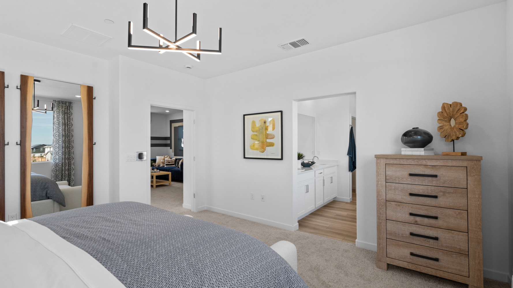 A bedroom with a bed and dresser.