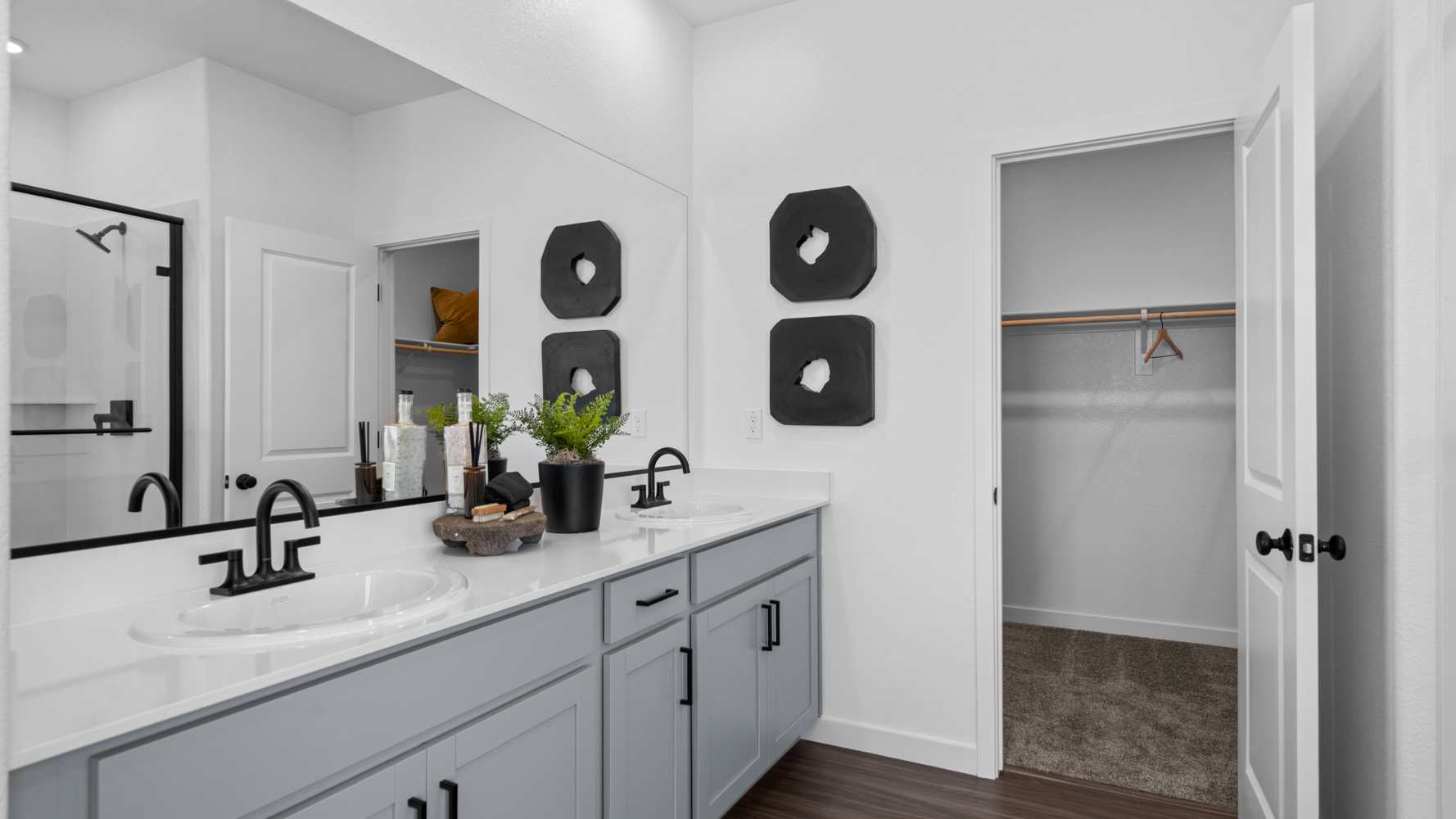 A bathroom with a sink and a shower unit.