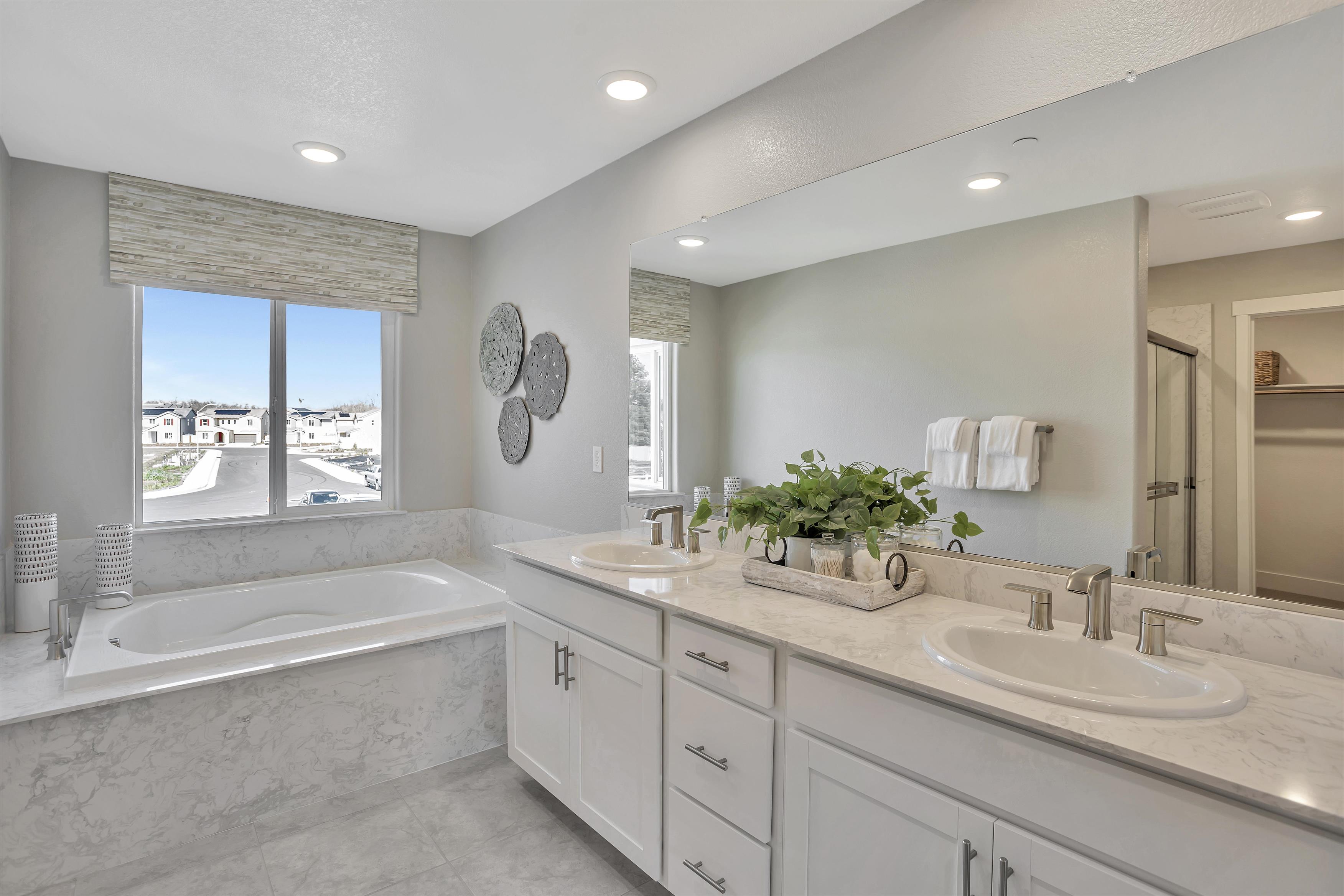 A bathroom with a tub sink and a bathtub.