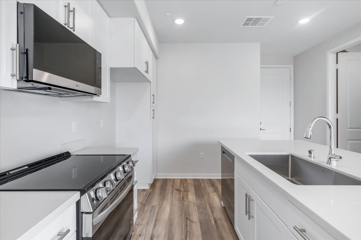 A kitchen with white cabinets.