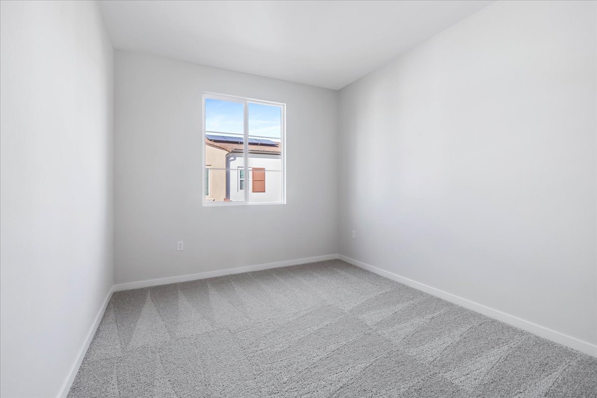 A room with a window and a carpet.