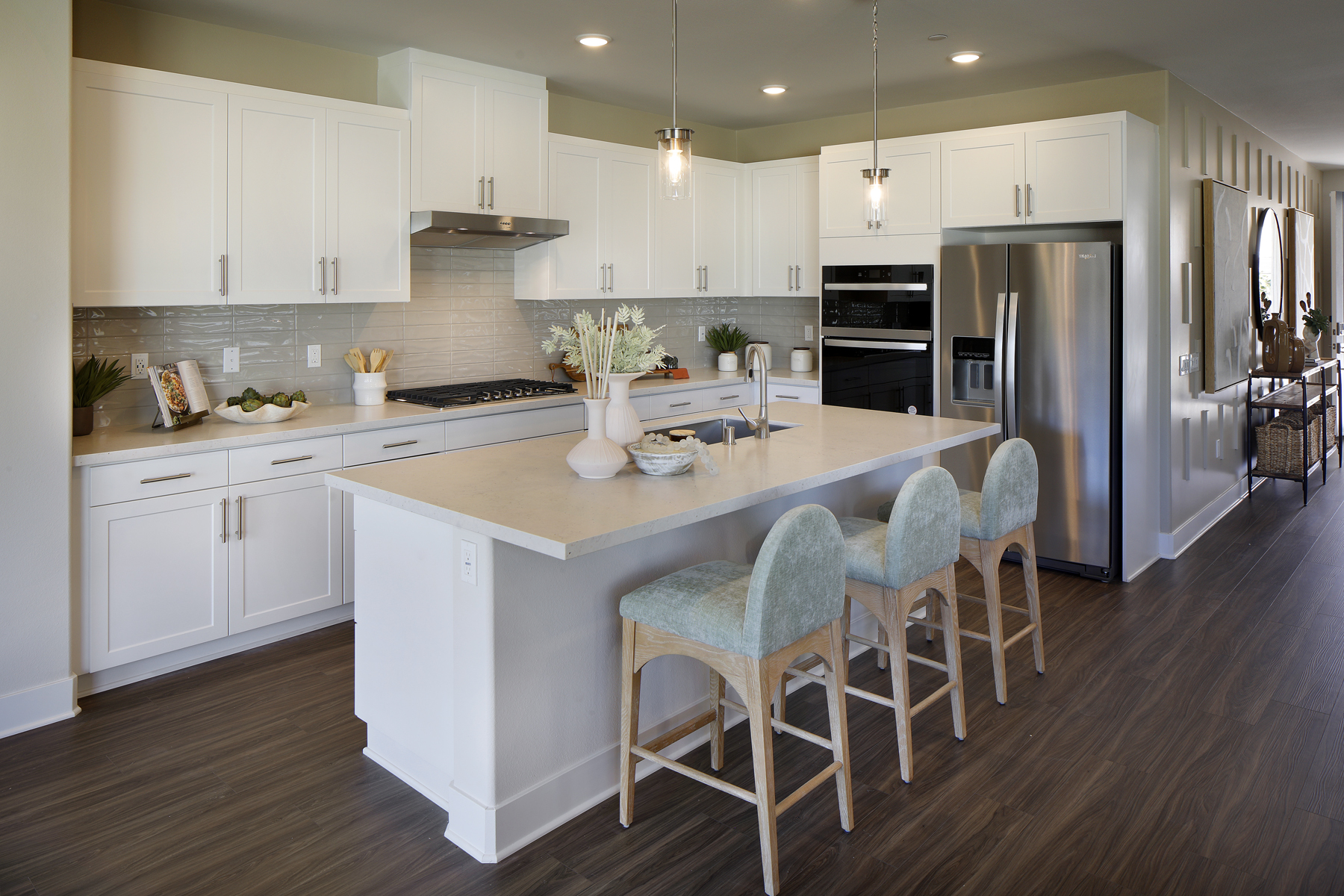 A kitchen with white cabinets.