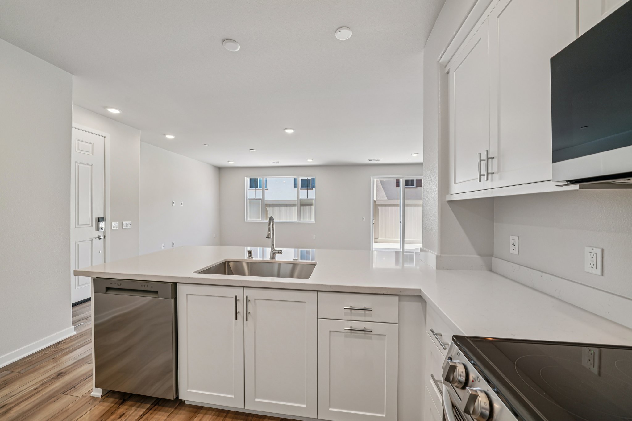 A kitchen with white cabinets.