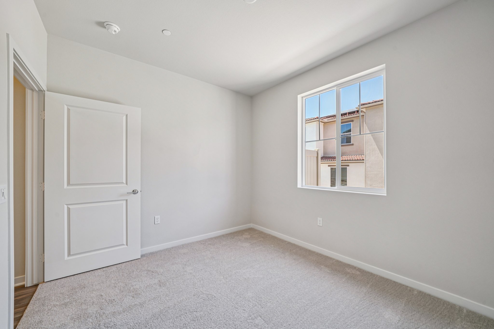 A room with a window and a door.