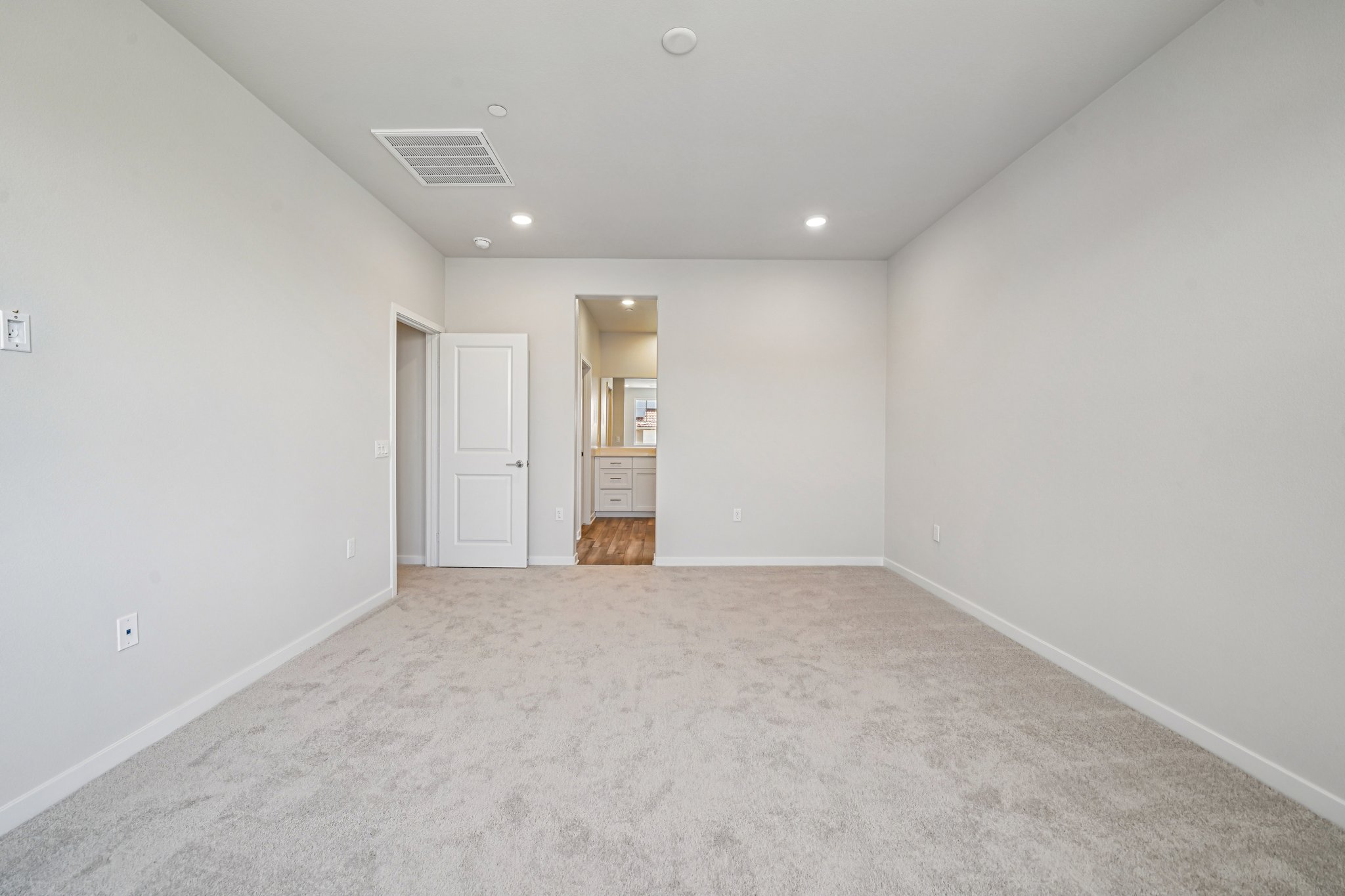 A hallway with white walls.