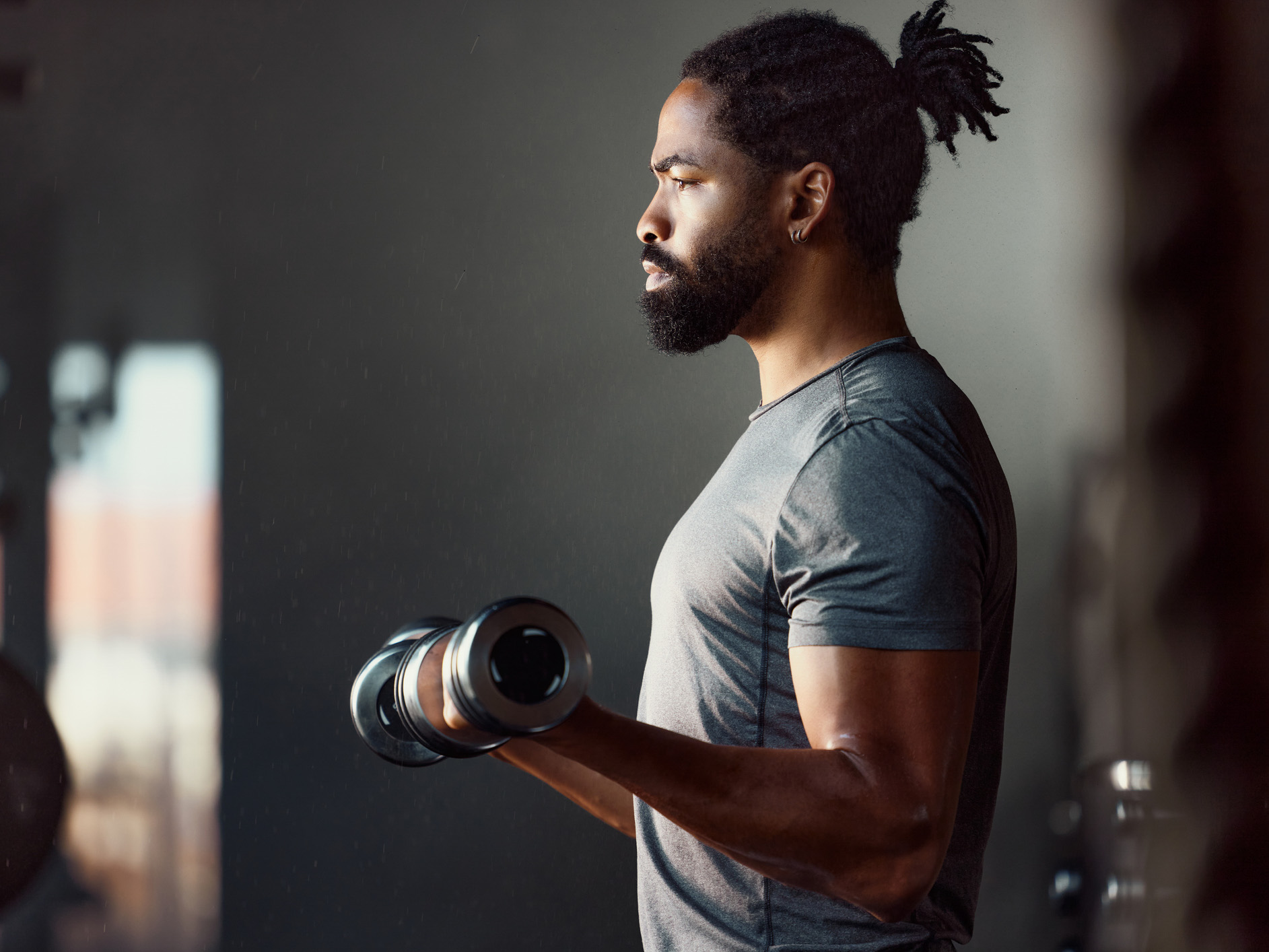 man in gym lifting weights- lifestyle image for community fitness center in good year az new construction homes for sale coming soon founder incentives.