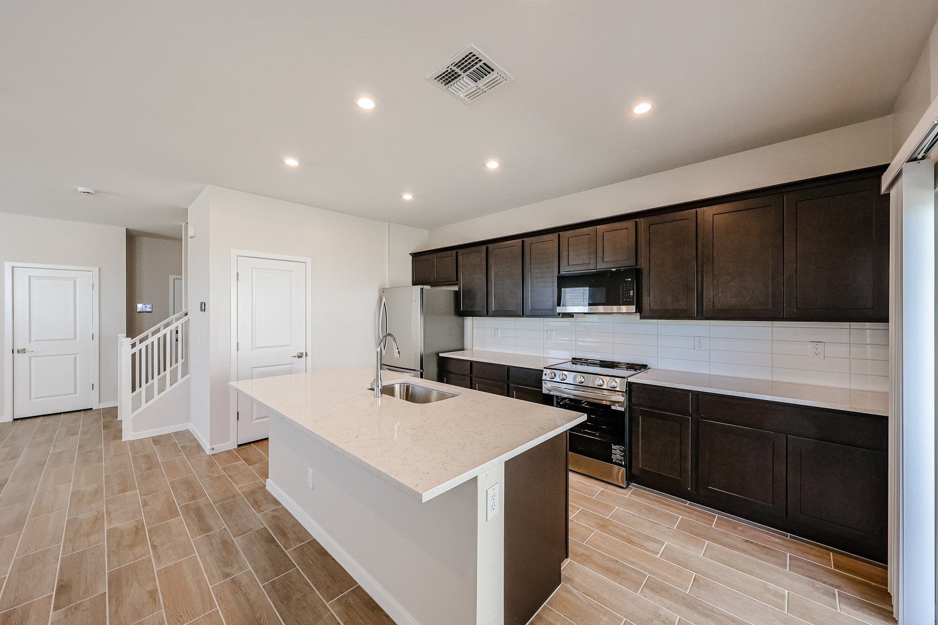 A kitchen with black cabinets.