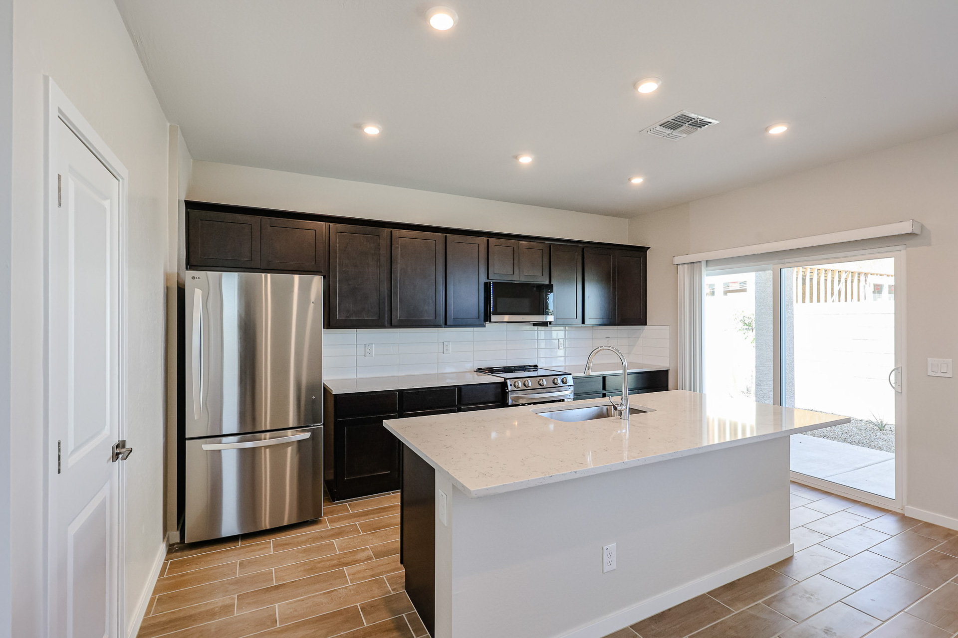 A kitchen with black cabinets.