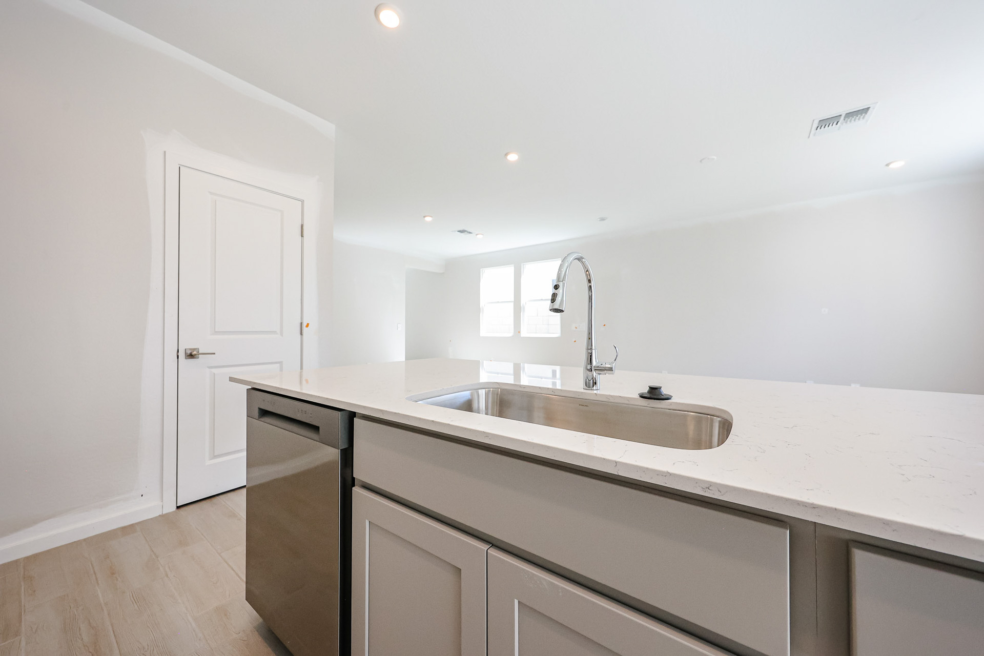 A kitchen with white cabinets.