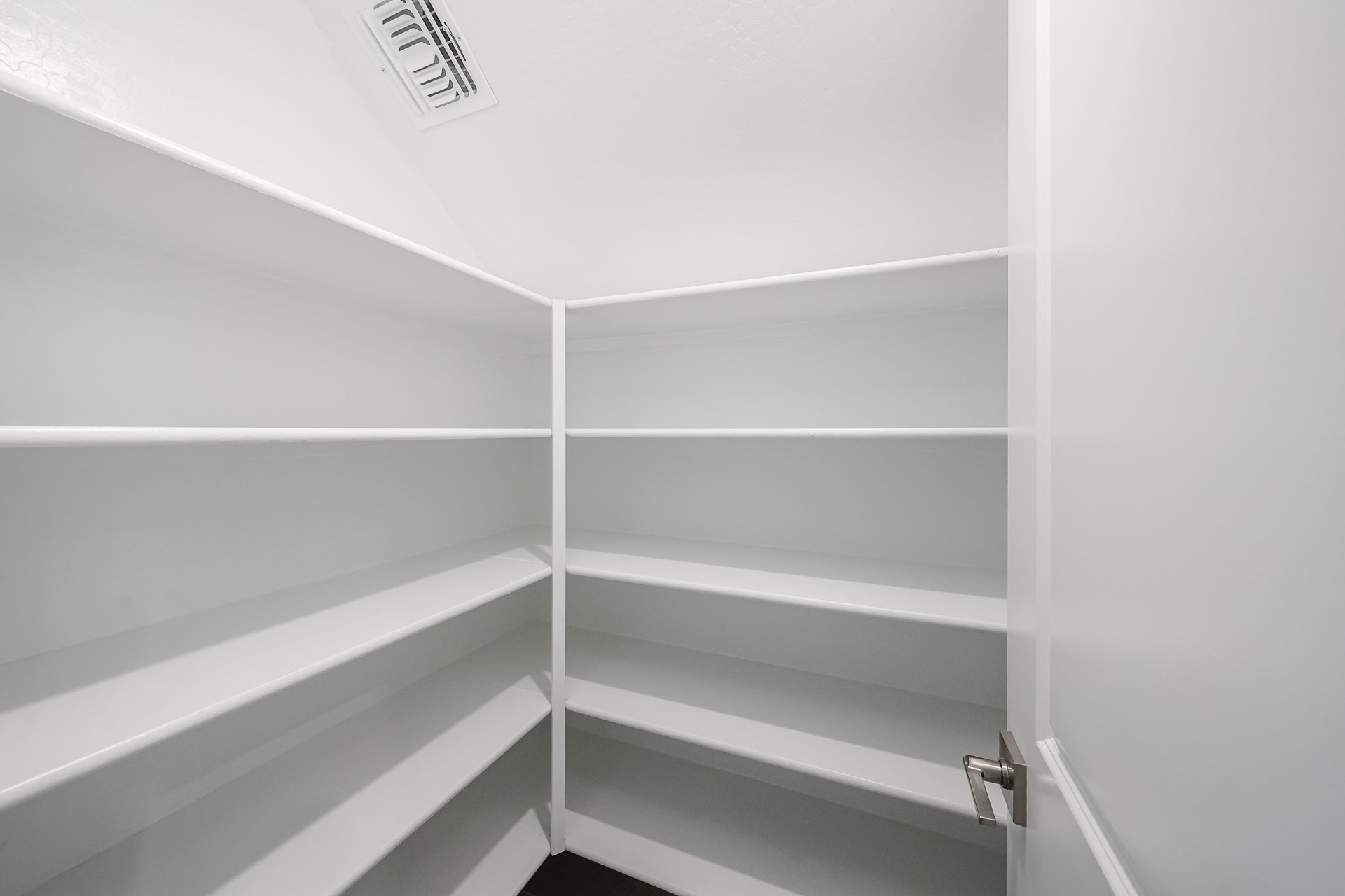 A white shelf with a sign on it.