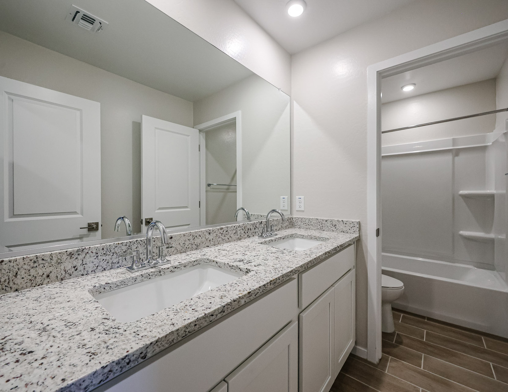 A bathroom with a tub sink and toilet.