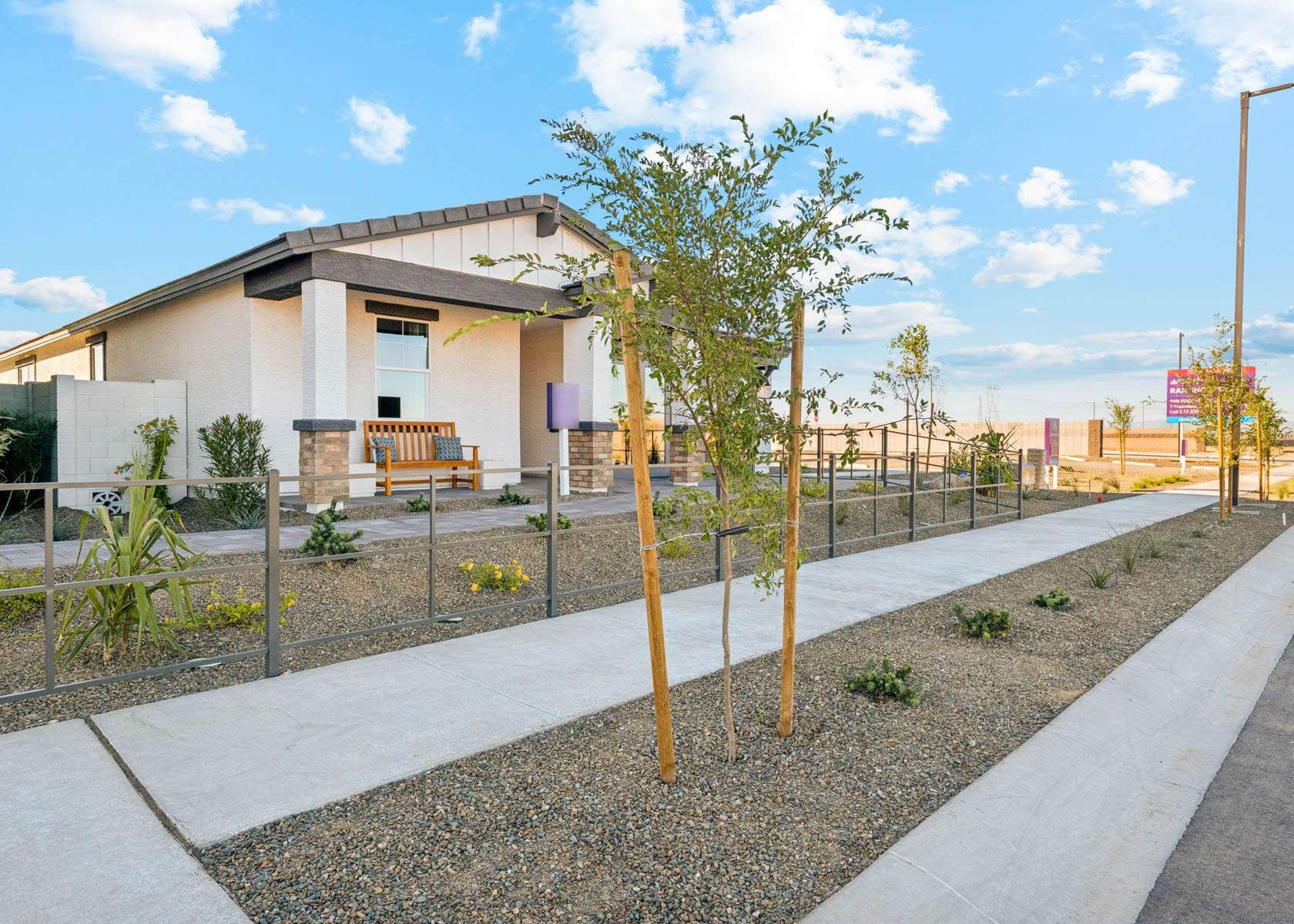 A building with a fence and trees.