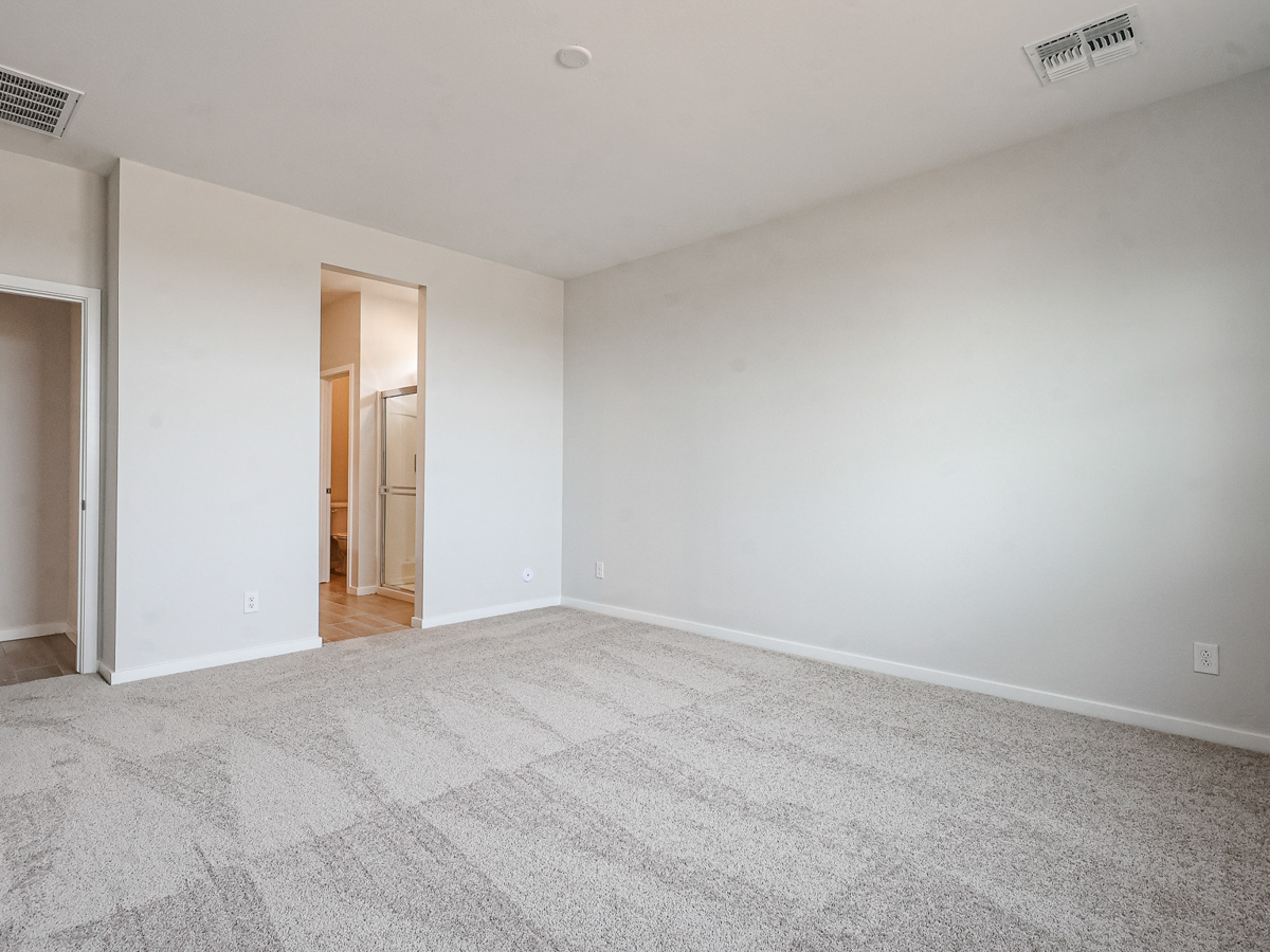 A room with carpet and a door.