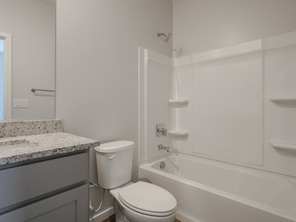 A bathroom with a tub toilet and sink.
