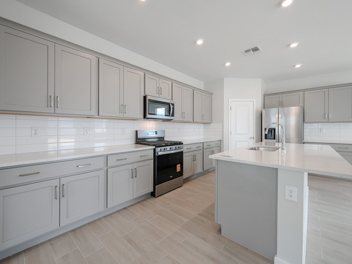 A kitchen with white cabinets.