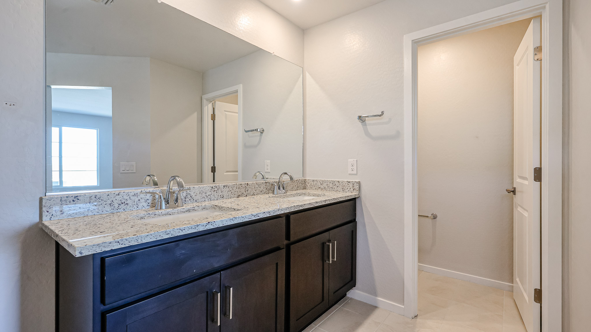 A bathroom with a marble countertop.