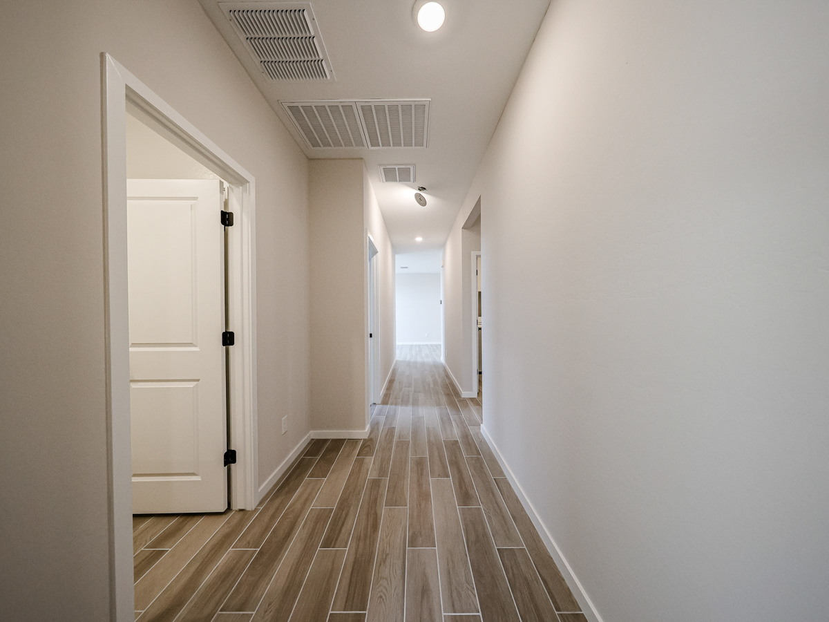 A hallway with white doors.