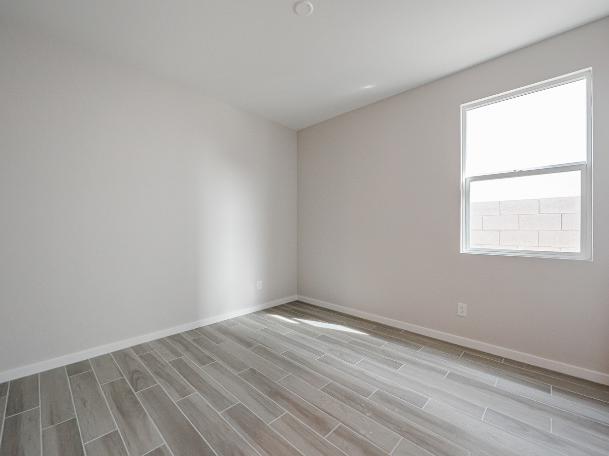 A room with a wood floor and a window.