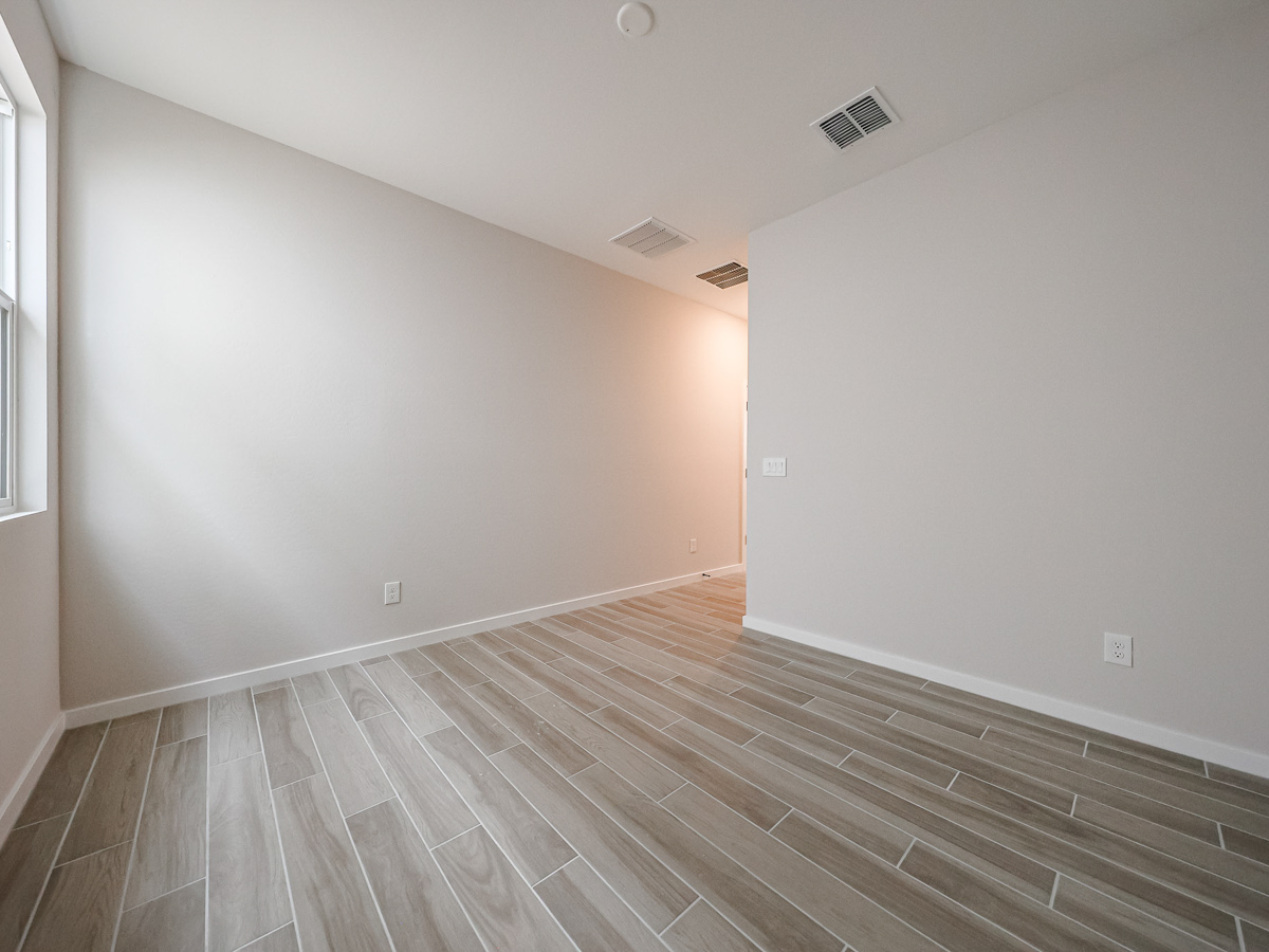 A room with a wood floor and a wood floor.