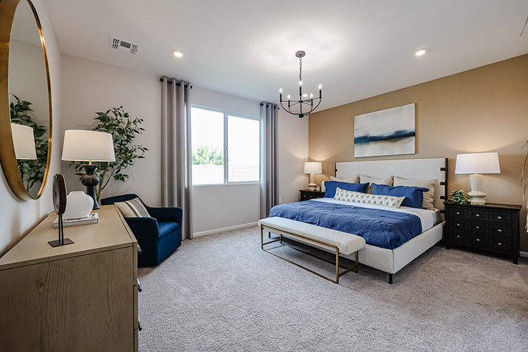 A bedroom with a bed and a bench.