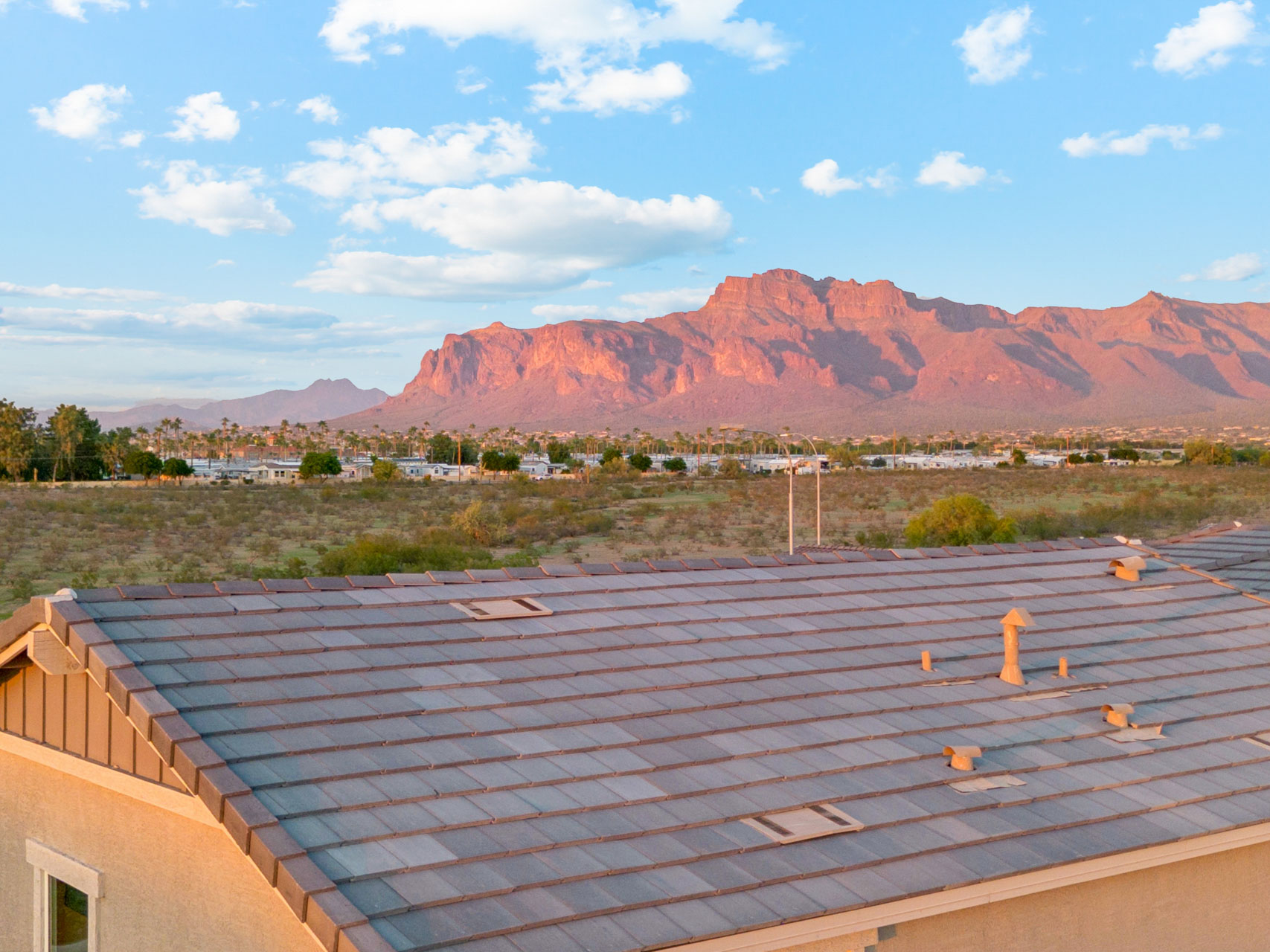 A roof with a mountain in the background.