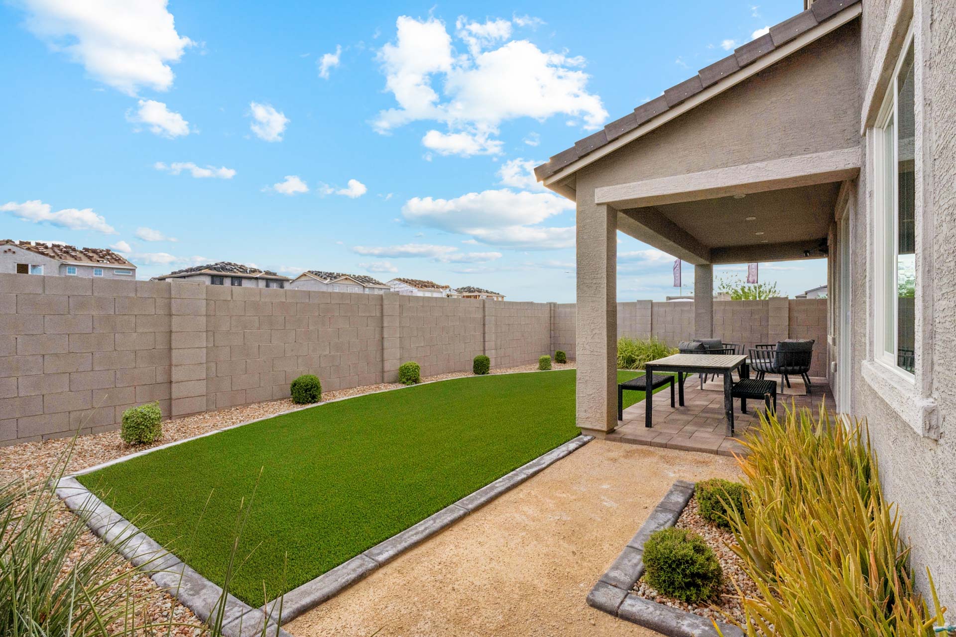 A backyard with a table and chairs.
