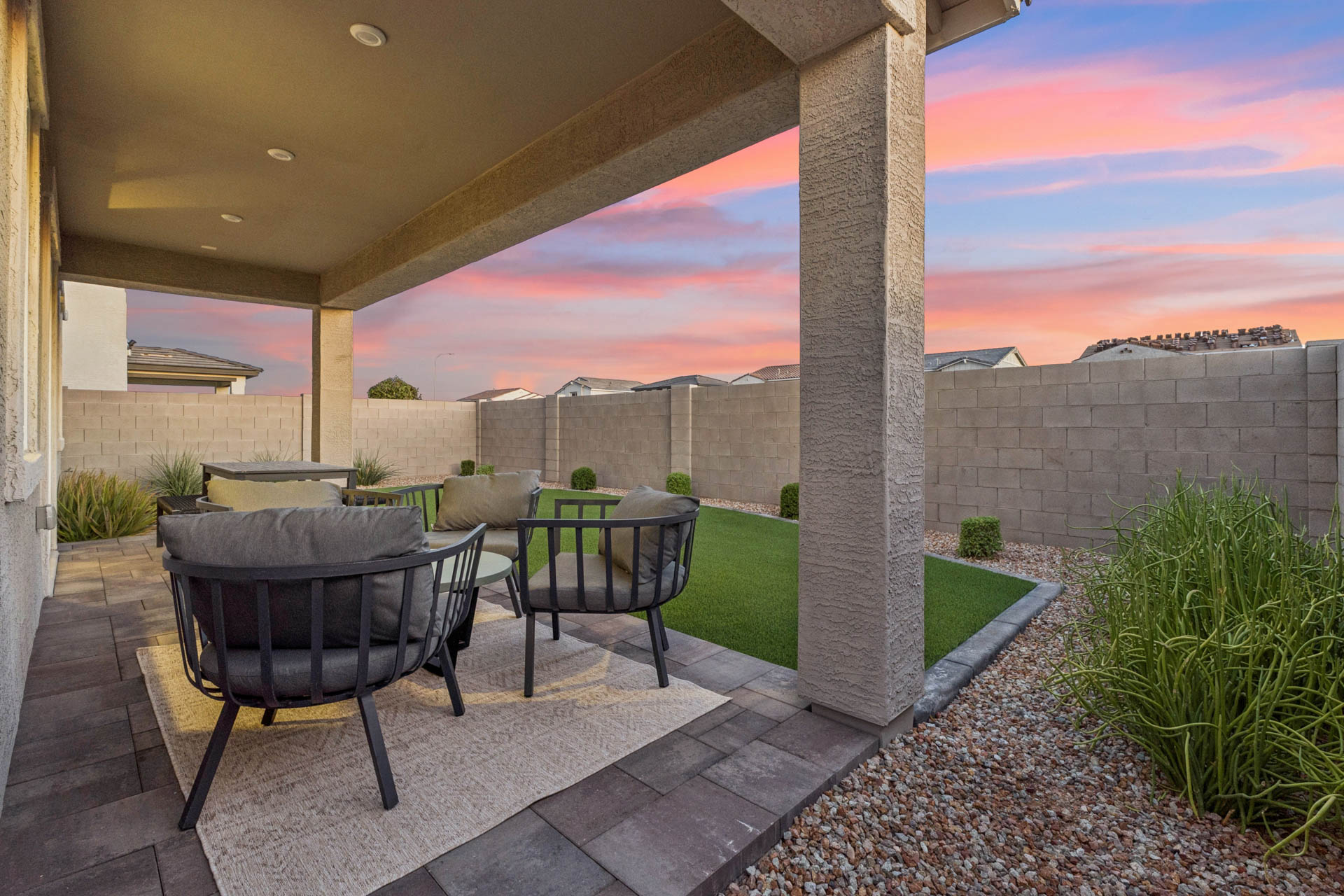 A patio with a table and chairs.