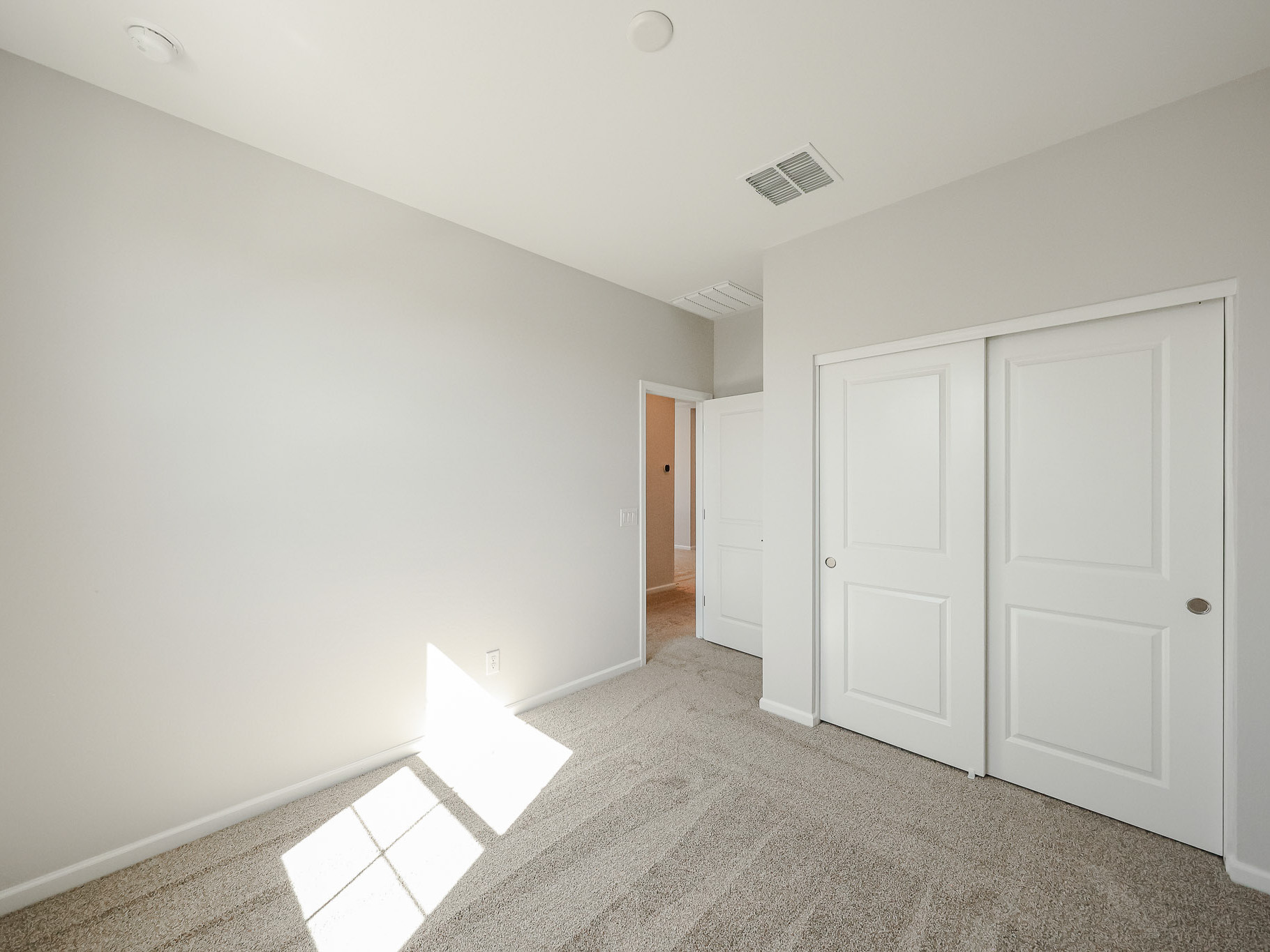 A hallway with white doors.