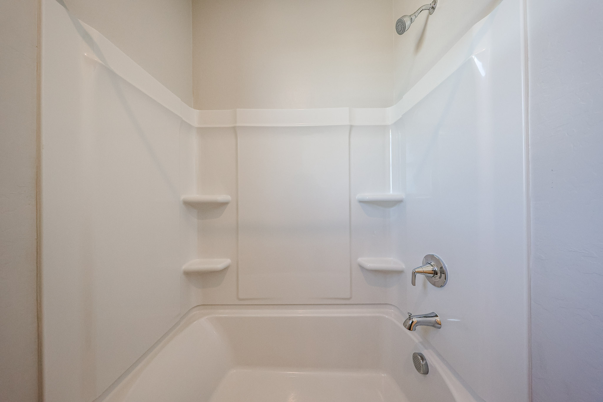 A bathtub with a sink and toilet.