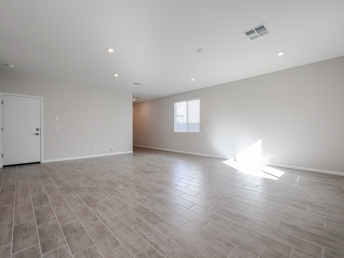 A room with a wood floor and a white door.