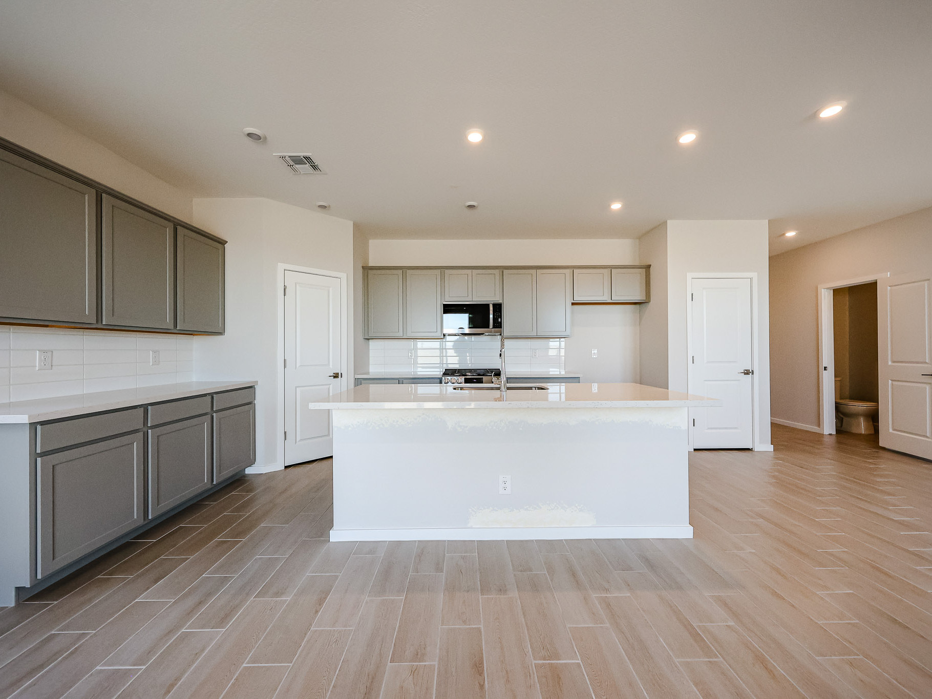 A kitchen with white cabinets.