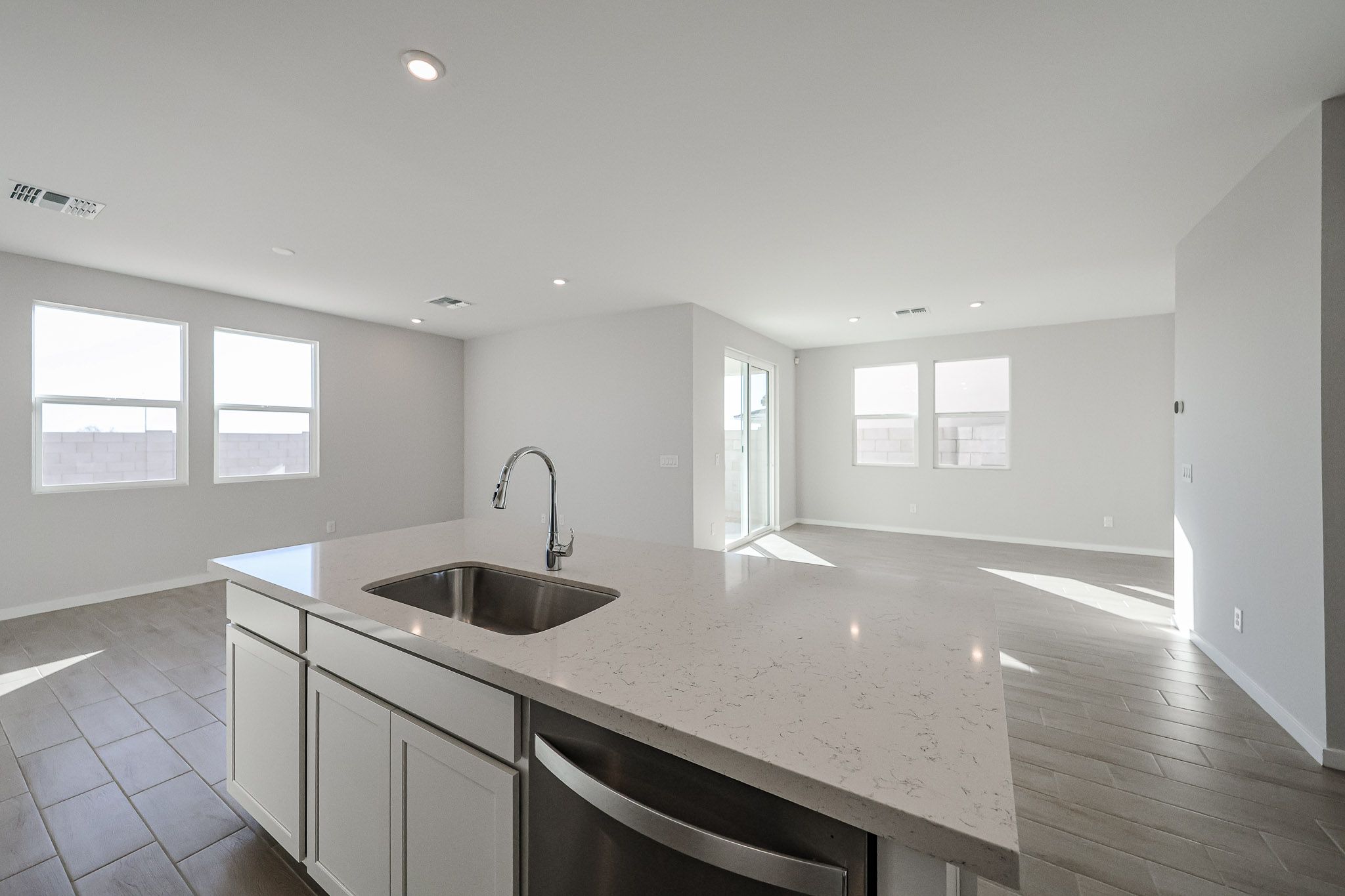 A kitchen with a sink and a large window.