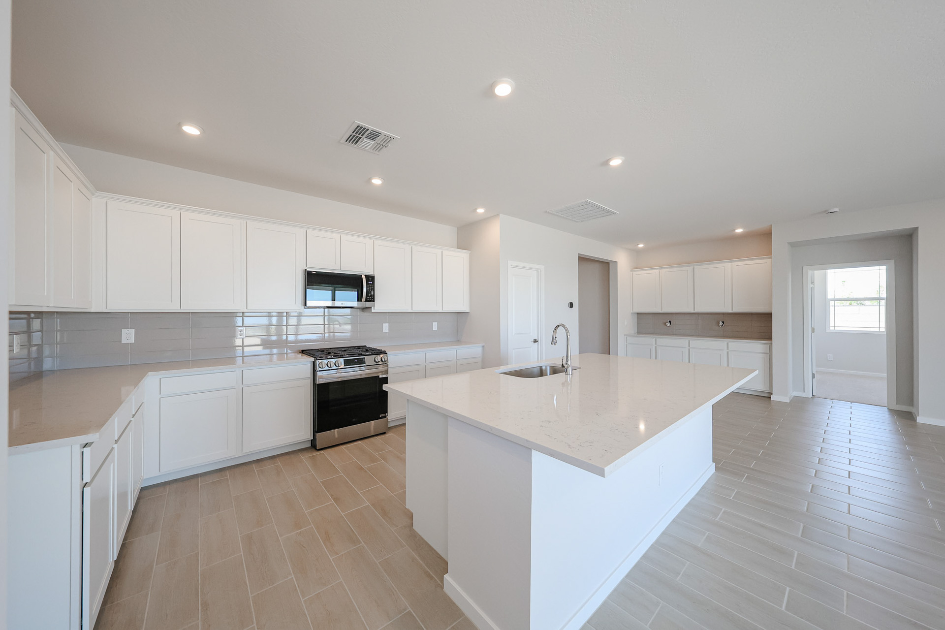A kitchen with white cabinets.
