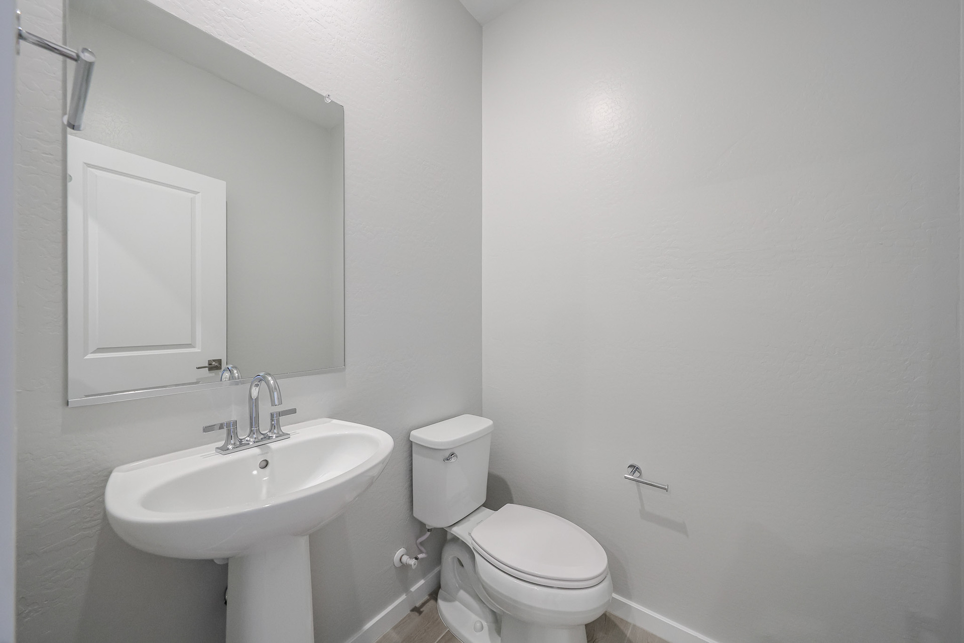 A bathroom with a toilet and sink.