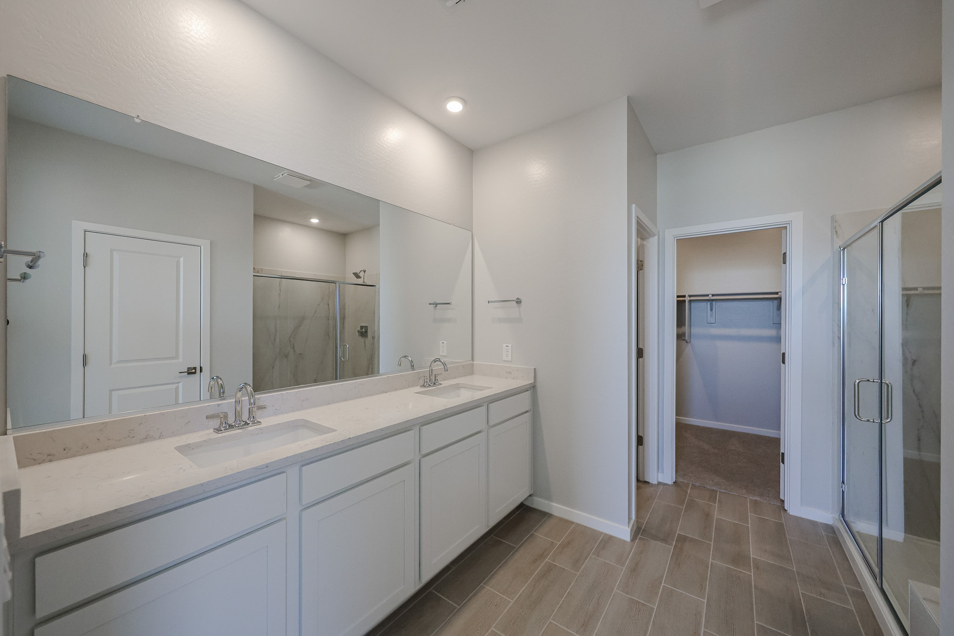 A bathroom with a large mirror.