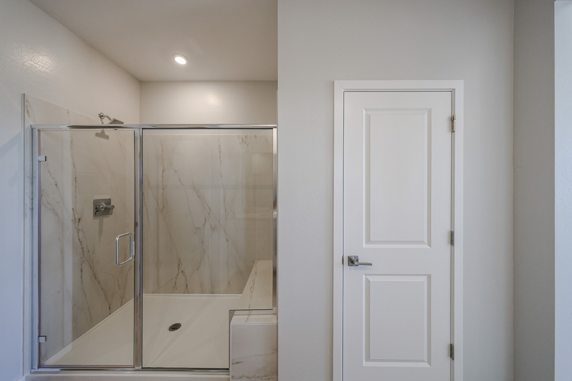 A bathroom with a glass shower.
