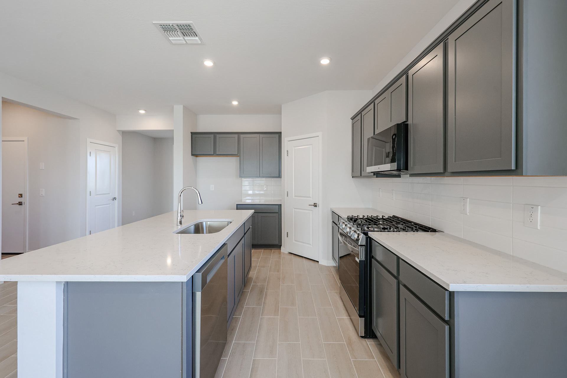 A kitchen with black cabinets.
