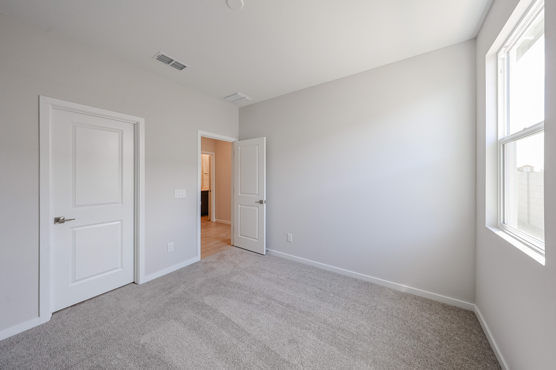 A room with white walls and a carpeted floor.