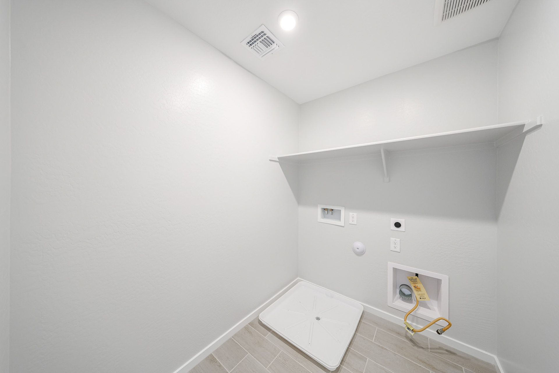 A white tiled room with a white tiled floor and a white tiled floor.