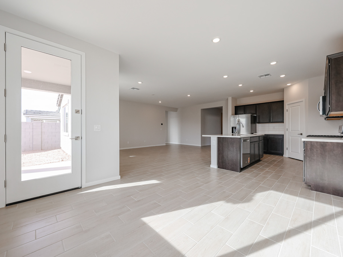 A large kitchen with a glass door.