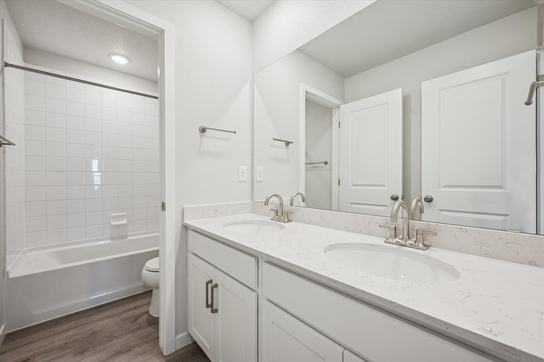 A bathroom with a tub sink and toilet.