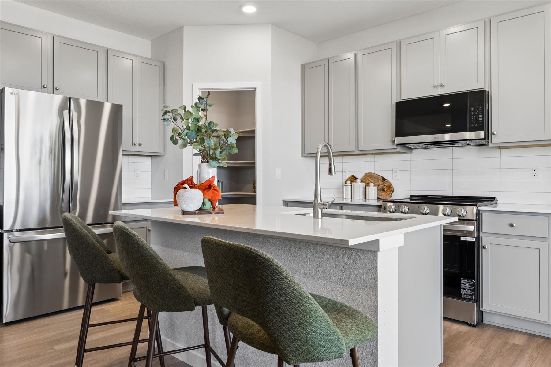 A kitchen with white cabinets.