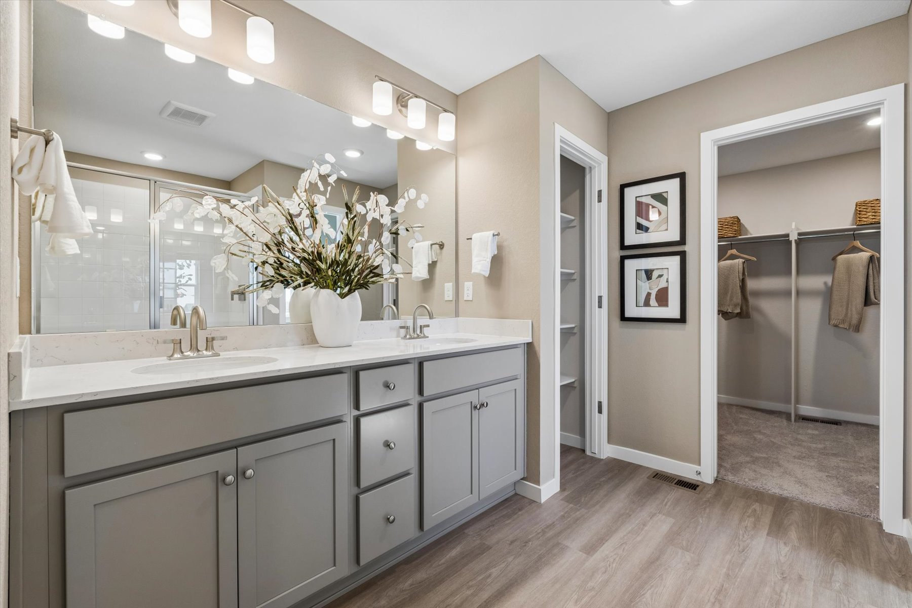 A bathroom with a large mirror.
