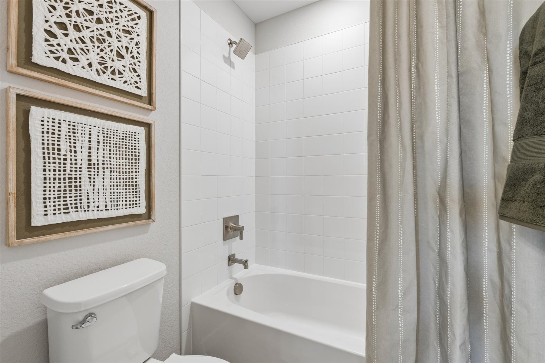 A bathroom with a tub and toilet.